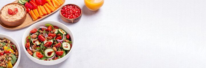 Vegan or veganuary feast with various salads ad healthy plates on light gray table