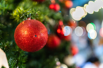 Close up of balls on christmas tree. Bokeh garlands in the background. New Year concept. Selective focus