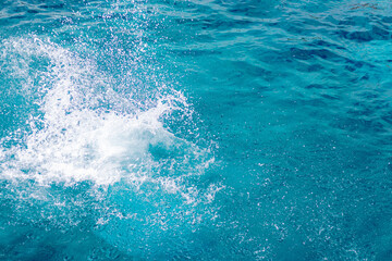 Splashes of blue, sea water with foam bubbles. A splash of nature on a summer day. blue sea background with splashing water. sea vacation concept.