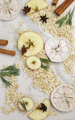 healthy tasty hearty high-calorie oatmeal with fruits and raspberries and blackberries and apples on a white kitchen board. for screensavers signboards labels banners flyers menus