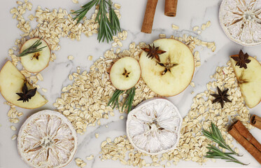 healthy tasty hearty high-calorie oatmeal with fruits and raspberries and blackberries and apples on a white kitchen board. for screensavers signboards labels banners flyers menus