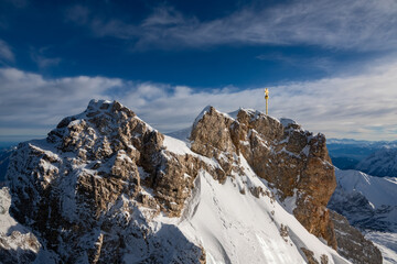 “Zugspitze“ peak with golden summit cross is the hightest mountain top in Germany on the border...