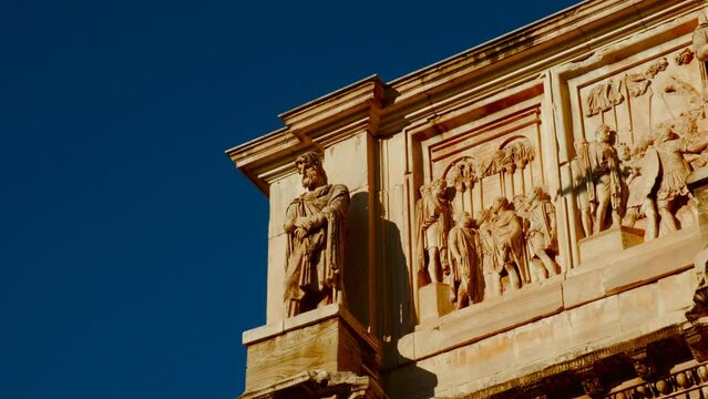 The Arch of Constantine at sunset in Rome, Italy. Built in 315 AD by Emperor Constantine, the arch stands tall, bathed in golden light