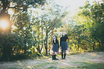girls with rabbit masks standing in the garden