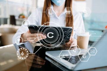 Copyright or patent concept, Person hand using laptop computer, tablet and smartphone with virtual screen copyright icon trademark, Creation ownership against piracy.
