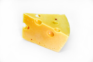 A large piece of cheese on a white background. A triangular piece of cheese with holes.