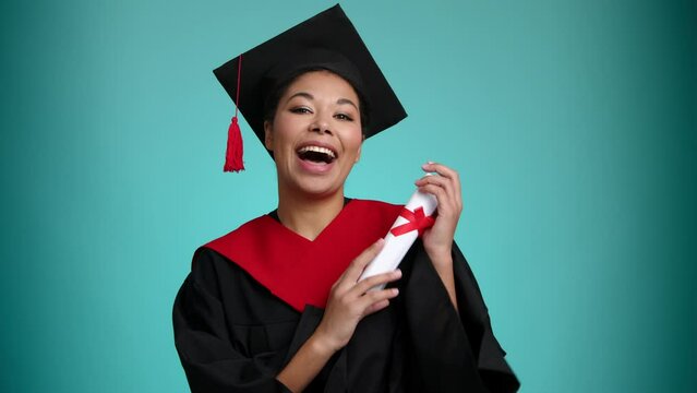 Close-up view of a happy, successful woman receiving her educational degree document. Portrait of female student catching her diploma. High quality 4k footage