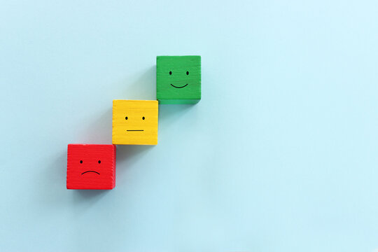 Top view image of cubes with happy and sad face. concept of happiness emotion and satisfaction