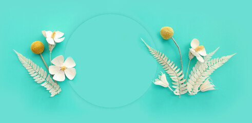 Top view image of white dry flowers over pastel blue background .Flat lay