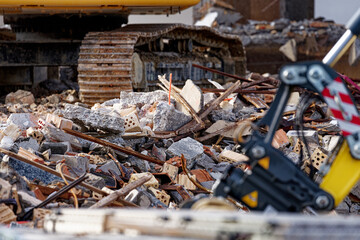 Deconstruction site with tearing down of an apartment building and heap of debris sprayed by water of hose on a sunny autumn day. Photo taken November 7th, 2022, Zurich, Switzerland.