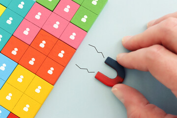 Concept image of a magnet attracting a group of people. metaphor of media influence and human...