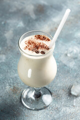 milky coffee cocktail on concrete stone background. vertical image. place for text