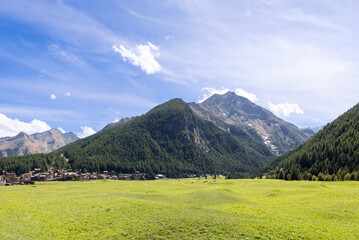 Panoramic shot of famous alpine green flat Sant Orso meadow created by inhabitants of neighboring...