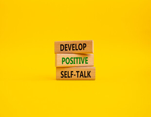 Develop positive self-talk symbol. Concept words Develop positive self-talk on wooden blocks. Beautiful yellow background. Business and Develop positive self-talk concept. Copy space