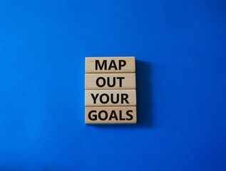 Goals symbol. Wooden blocks with words 'Map out your goals'. Beautiful blue background. Business and 'Map out your goals' concept. Copy space.