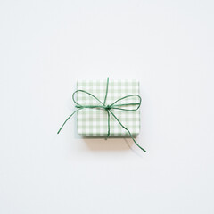 Green gift box isolated on white background. top view, copy space