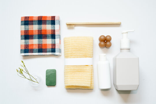 Bathroom spa products. shampoo, shower soap, towel, toothbrush on white background. flat lay, top view, copy space