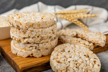 puffed rice bread on black texture background. Healthy crunchy snack. Whole grain crispy bread. Healthy food. Diet. Copy space. Place for text.