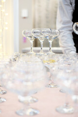 Empty wine or champagne glasses on table are in pyramid.