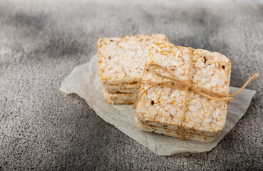 puffed rice bread on black texture background. Healthy crunchy snack. Whole grain crispy bread. Healthy food. Diet. Copy space. Place for text.