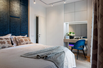 Fototapeta na wymiar Stylish bedroom interior with an elegant toilet table and access to the balcony