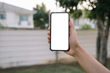 Man holding smartphone with blank screen, close-up of hands. Space for text.