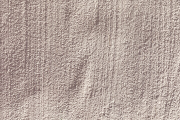 plaster wall textured with lines in light red color