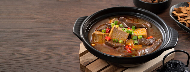 Spicy duck blood jelly soup and stinky tofu with scallion and chili pepper topping.
