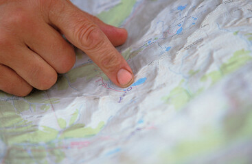 A woman finds the best way for her team to navigate through the next stretch of an adventure race.