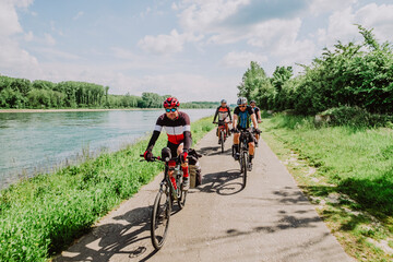 A group of friends cycling in the River Rin route, Germany