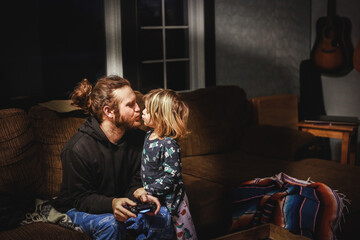 Little boy kissing his dad goodnight
