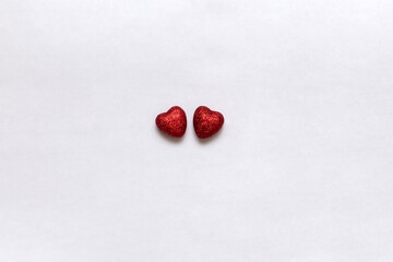 The 14th of February is Valentine's Day two little red hearts on white background 