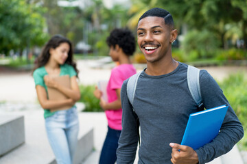 Fototapeta na wymiar Laughing african american male student with group of brazilian female young adults