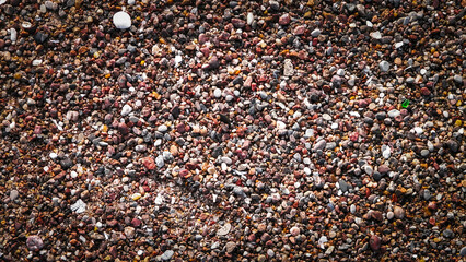 Sand and gravel on a seashore as nature background.