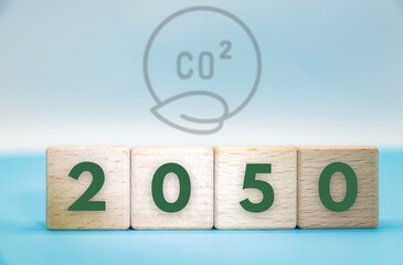 Net zero 2050 by carbon neutral concept. greenhouse gas emissions awareness.  wooden cubes blocks with NetZero icon in blue background.