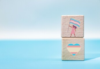 International Transgender Day of Visibility concept with icons on wooden cube blocks.
