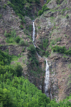 evocative image of a waterfall in the mountains

