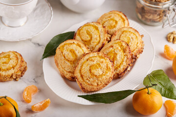 Cottage cheese Cookies in a shape of spiral with orange filling and walnuts. Delicious homemade dessert.