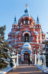 Fototapeta na wymiar Irkutsk. Kazan Orthodox Cathedral during the Christmas holidays. The churchyard is decorated with figures of Saints carved from ice. Beautiful winter cityscape