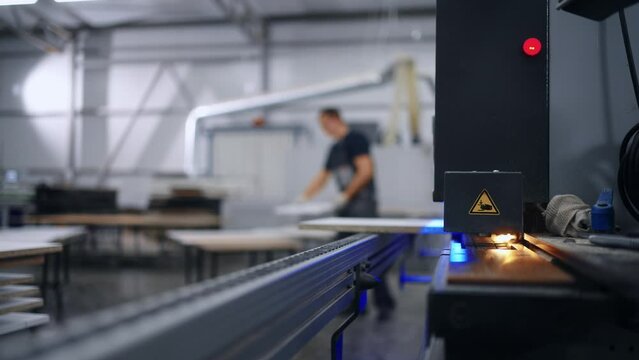 modern edge banding machine in furniture factory, closeup, finish carpentry, automated equipment