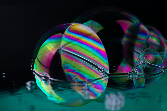 bright rainbow multicolored cosmic
futuristic transparent shiny textures in the form of soap bubbles on a mirror surface with water drops. for business cards labels headpieces signs flyers