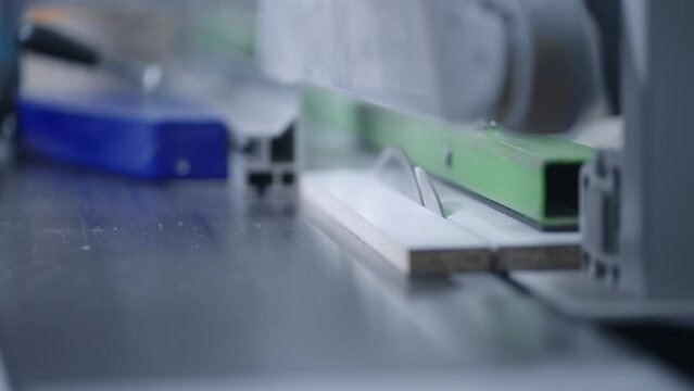 closeup view of sawing machine in modern furniture production, automated robotic system