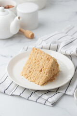Piece Of Layered Homemade Honey Cake on the white table