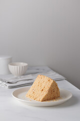 Piece Of Layered Homemade Honey Cake on the white table