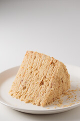 Piece Of Layered Homemade Honey Cake on the white table