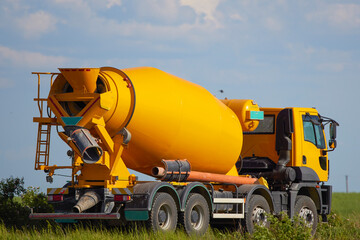 a yellow car to transport cement seen from the side