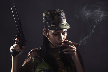 a female soldier with a cigar and a pistol on a black background