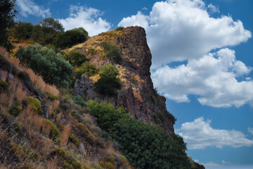 Fototapeta premium Cloud clusters and sky view from the top of a mountain with various dwarf Mediterranean scrub plants