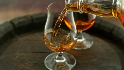 Super slow motion of pouring cognac into glass with speed motion. Filmed on high speed cinema camera, 1000 fps, placed on high speed cine bot. Speed ramp effect.