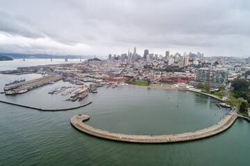 Aquatic Park Pier , Cove and Municipal Pier in San Francisco. Maritime National Historic Park in Background. Cityscape of San Francisco. California. Drone - obrazy, fototapety, plakaty